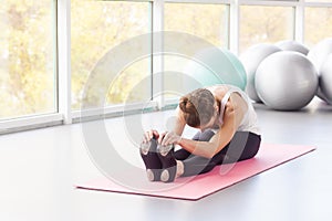 BalÄsana. Seated forward bend. Childâ€™s Pose. Woman doing tilt